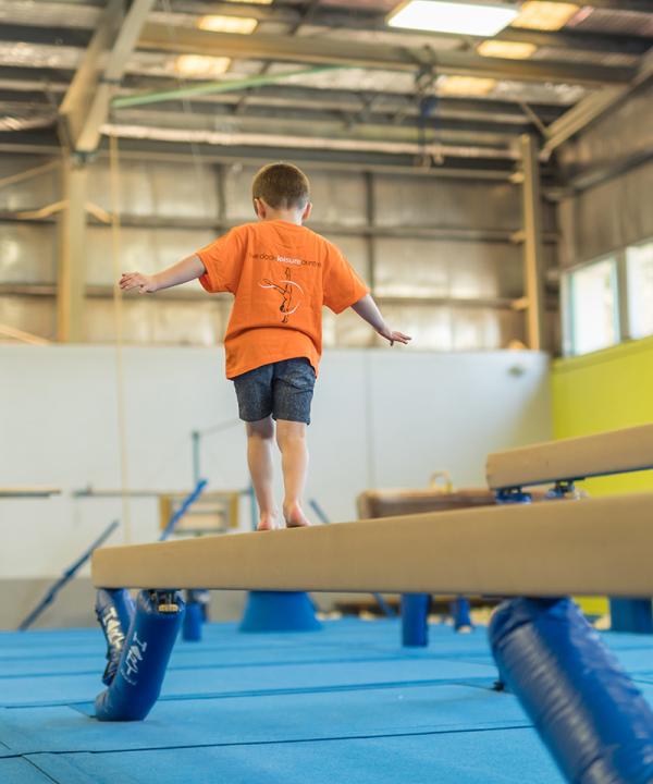 Child balancing on beam