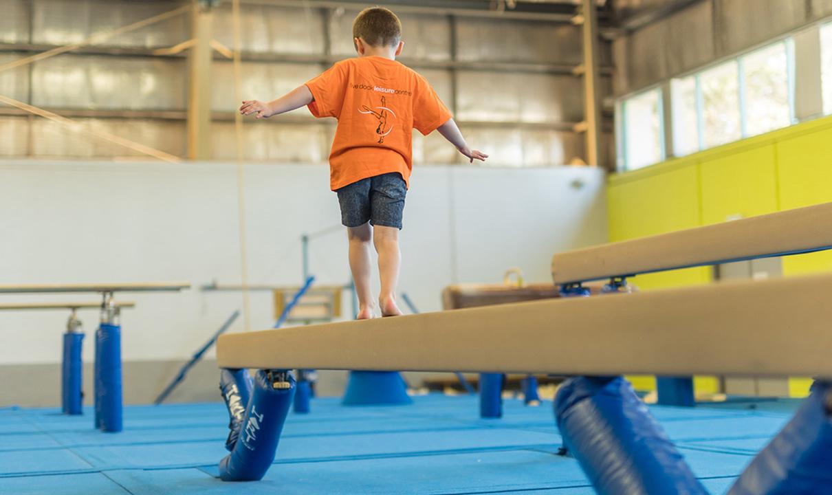 Boy on balancing beam.