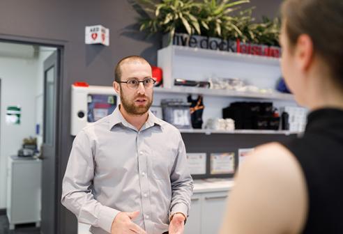 Staff member talking to visitor at the Five Dock Leisure Centre.